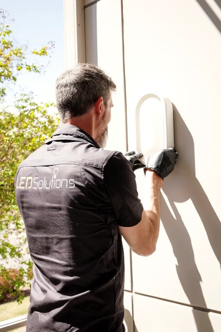 Kieran from LED Solutions fitting an exterior wall light