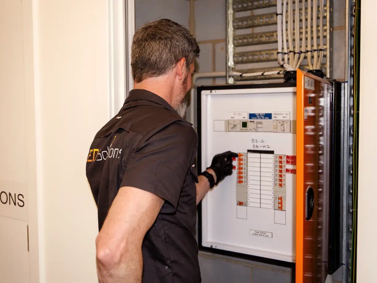 Kieran from LED Solutions working on a switchboard